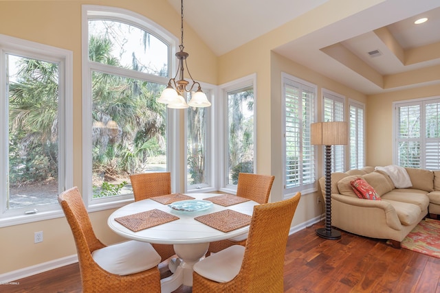 dining room with dark hardwood / wood-style floors and a chandelier