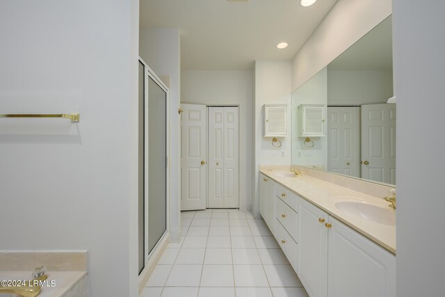 bathroom featuring tile patterned flooring, vanity, and an enclosed shower