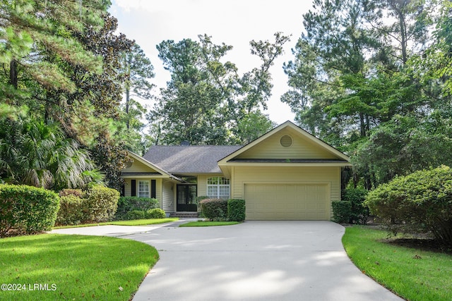 ranch-style house featuring a garage and a front yard