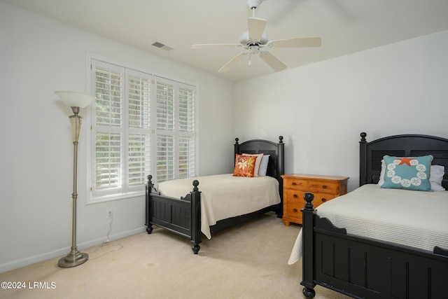 bedroom with light carpet and ceiling fan