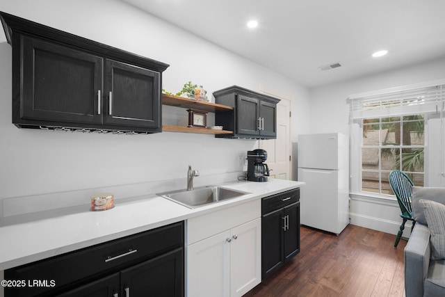714 Island Cir E, Saint Helena Island, SC 29920 - kitchen with freestanding refrigerator, a sink, dark wood finished floors, light countertops, and recessed lighting