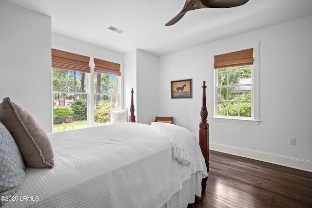 714 Island Cir E, Saint Helena Island, SC 29920 - bedroom with multiple windows, baseboards, dark wood-type flooring, and ceiling fan