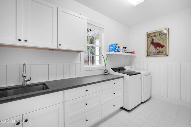 714 Island Cir E, Saint Helena Island, SC 29920 - laundry room with washing machine and dryer, cabinet space, a wainscoted wall, and light tile patterned floors