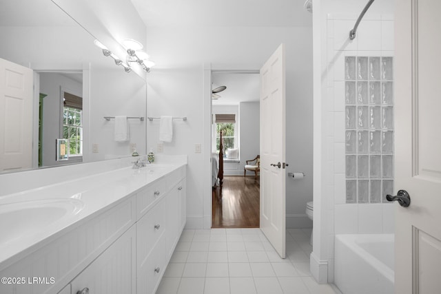 714 Island Cir E, Saint Helena Island, SC 29920 - bathroom featuring double vanity, toilet, connected bathroom, tile patterned floors, and baseboards