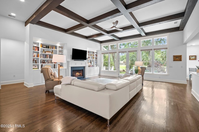 714 Island Cir E, Saint Helena Island, SC 29920 - living room featuring baseboards, a lit fireplace, dark wood-style flooring, beamed ceiling, and built in features