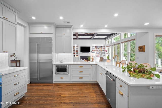 714 Island Cir E, Saint Helena Island, SC 29920 - kitchen with appliances with stainless steel finishes, recessed lighting, backsplash, light countertops, and dark wood-style flooring