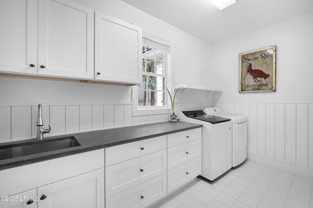 714 Island Cir E, Saint Helena Island, SC 29920 - washroom with washer and clothes dryer, cabinet space, wainscoting, and light tile patterned floors
