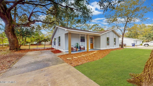 view of front of home with a porch and a front lawn