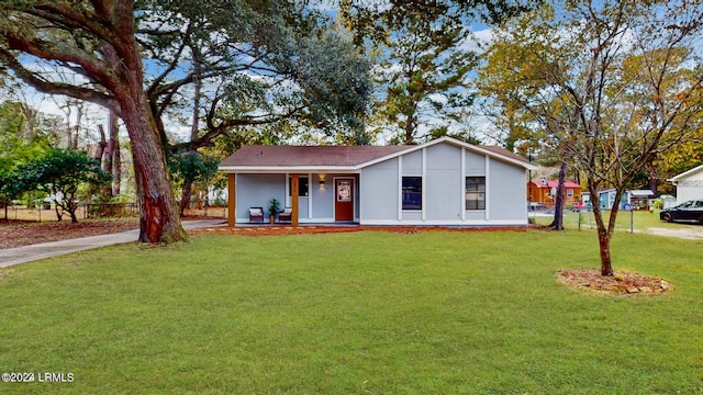 single story home with a front yard and covered porch