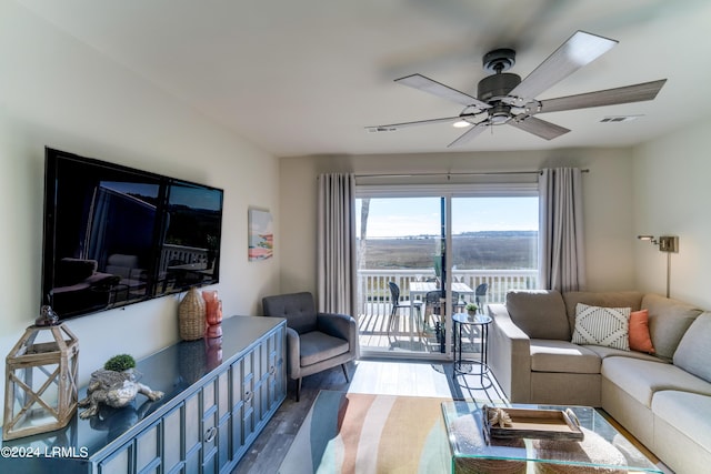 living room with ceiling fan and light hardwood / wood-style floors