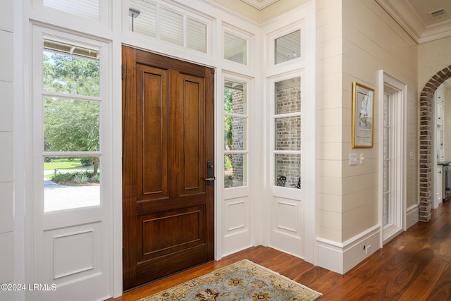 foyer with dark hardwood / wood-style flooring and ornamental molding