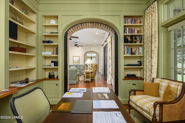 office space with crown molding, dark wood-type flooring, and ceiling fan