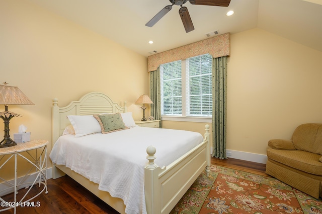 bedroom featuring dark hardwood / wood-style flooring, lofted ceiling, and ceiling fan