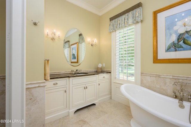 bathroom featuring crown molding, vanity, and a bathing tub