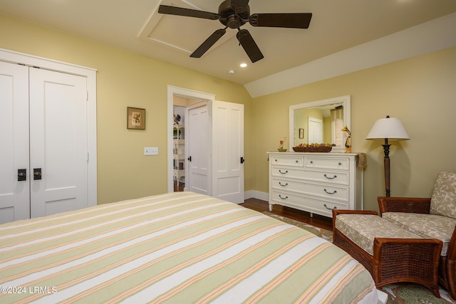 bedroom with dark hardwood / wood-style flooring, lofted ceiling, a closet, and ceiling fan