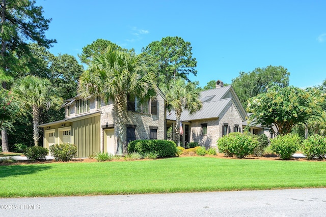 view of front of property featuring a garage and a front yard