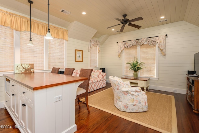 dining area featuring vaulted ceiling, dark wood-type flooring, and wooden ceiling