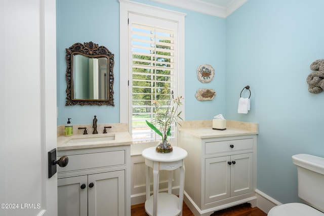 bathroom featuring crown molding, vanity, and toilet