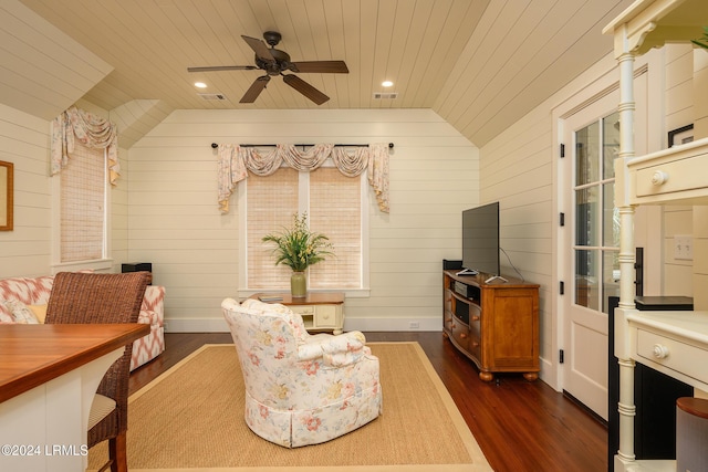 living area featuring wooden walls, lofted ceiling, dark hardwood / wood-style flooring, ceiling fan, and wood ceiling