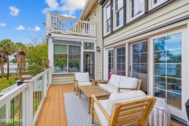 wooden terrace with an outdoor hangout area