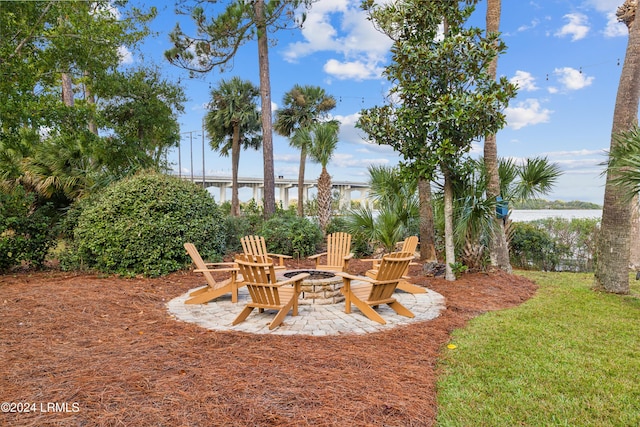 view of yard with a water view and an outdoor fire pit