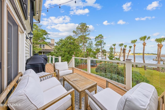 wooden terrace featuring a water view, outdoor lounge area, and grilling area