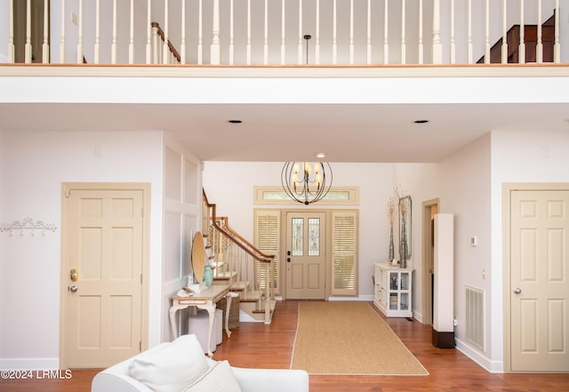 entrance foyer with hardwood / wood-style flooring and a notable chandelier