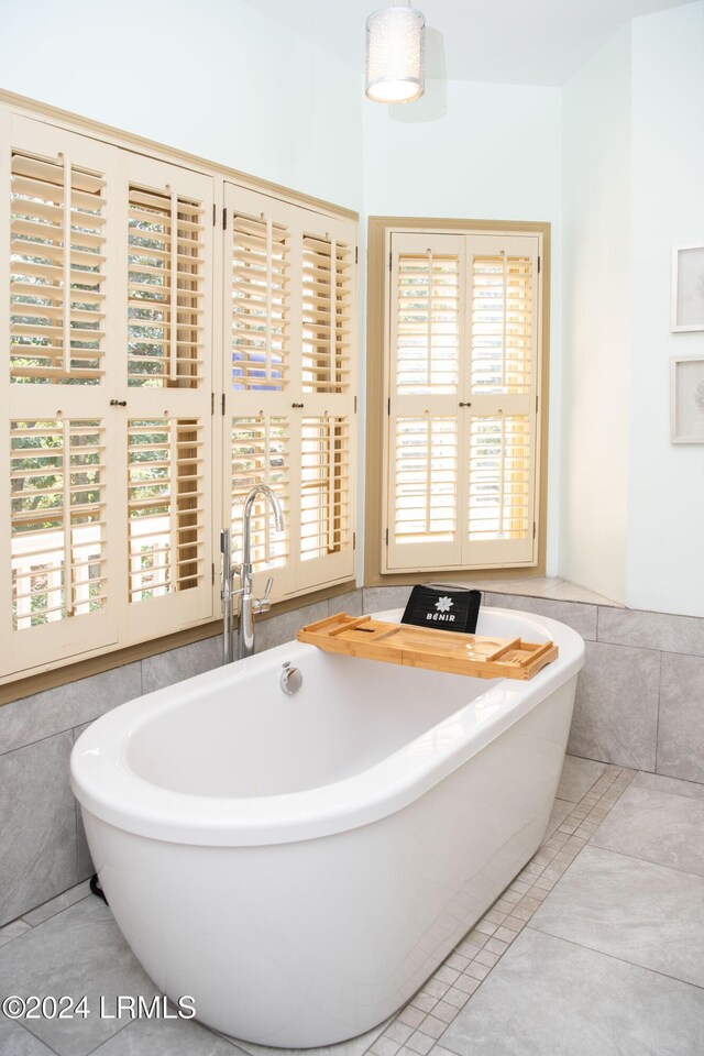 bathroom featuring tile patterned floors and a tub