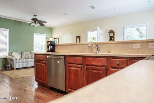 1003 9th St, Port Royal, SC 29935 - kitchen with dishwasher, light wood-type flooring, light countertops, crown molding, and healthy amount of natural light