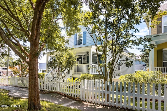 1003 9th St, Port Royal, SC 29935 - view of front of home featuring covered porch, a ceiling fan, stairway, and a fenced front yard