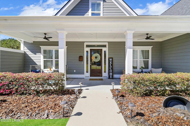 doorway to property with ceiling fan and a porch