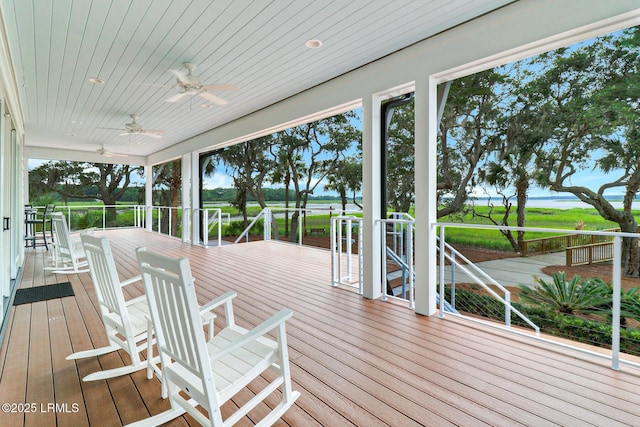 wooden deck featuring ceiling fan