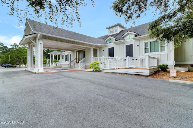 view of front of house with board and batten siding and roof with shingles