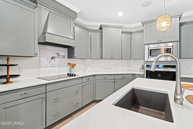 kitchen with appliances with stainless steel finishes, custom exhaust hood, and gray cabinetry