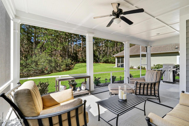 sunroom / solarium featuring a ceiling fan