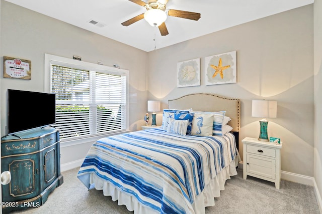 carpeted bedroom with a ceiling fan, visible vents, and baseboards