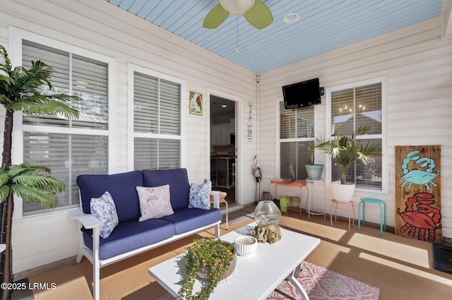 sunroom featuring ceiling fan