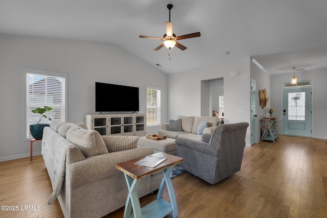 living room featuring vaulted ceiling, wood-type flooring, plenty of natural light, and ceiling fan