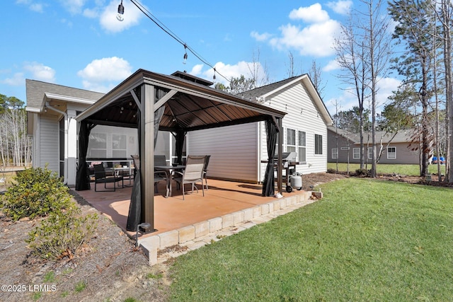 back of property with a gazebo, a patio area, and a lawn