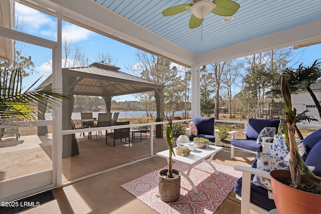 view of patio / terrace with an outdoor living space, a gazebo, ceiling fan, and a water view