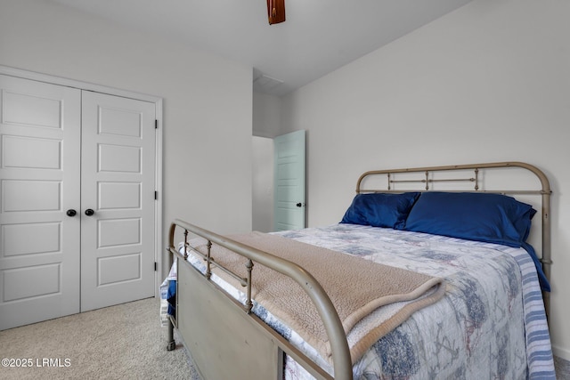 carpeted bedroom featuring a closet and ceiling fan