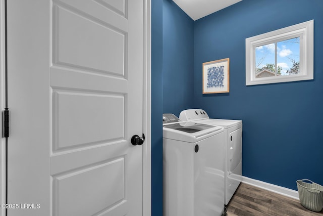 clothes washing area with dark hardwood / wood-style flooring and washer and clothes dryer