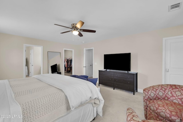 1216 Hearthstone Dr, Ridgeland, SC 29936 - bedroom with a walk in closet, ceiling fan, visible vents, a closet, and light carpet