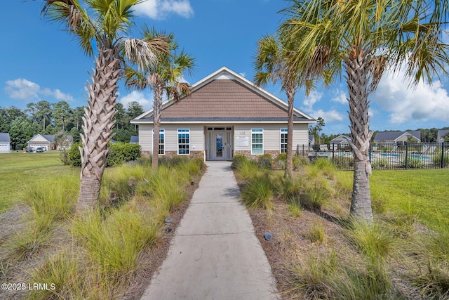 1216 Hearthstone Dr, Ridgeland, SC 29936 - bungalow with fence, a front yard, and stone siding