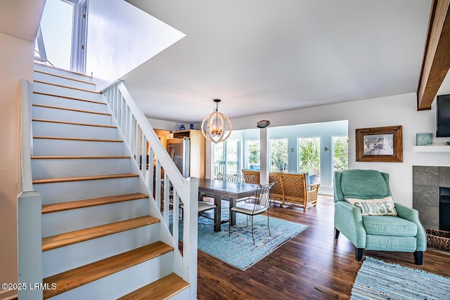 262 Deer Run Ln, Fripp Island, SC 29920 - dining space featuring stairway, dark wood-style floors, a chandelier, and a fireplace