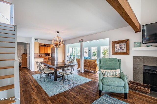262 Deer Run Ln, Fripp Island, SC 29920 - dining room featuring stairway, a chandelier, dark wood-style flooring, and a tile fireplace