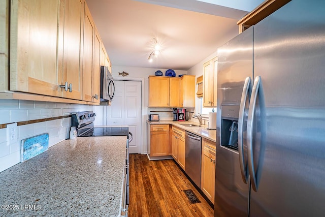 262 Deer Run Ln, Fripp Island, SC 29920 - kitchen with appliances with stainless steel finishes, a sink, tasteful backsplash, light stone counters, and light brown cabinets