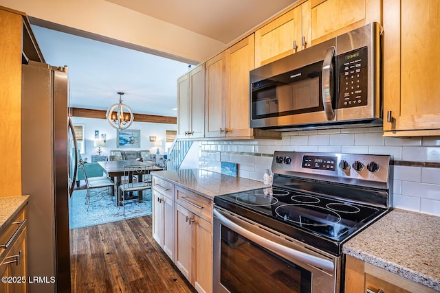 262 Deer Run Ln, Fripp Island, SC 29920 - kitchen with stainless steel appliances, dark wood-style flooring, a chandelier, light stone counters, and decorative backsplash