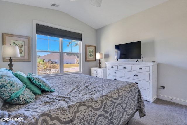 carpeted bedroom with vaulted ceiling