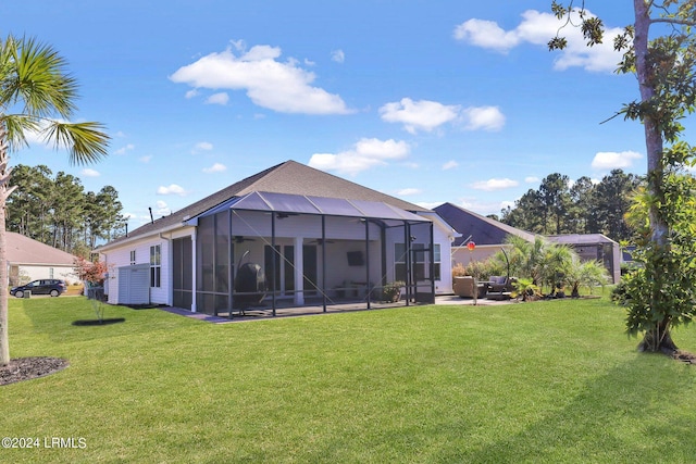 rear view of property featuring a patio, glass enclosure, and a lawn